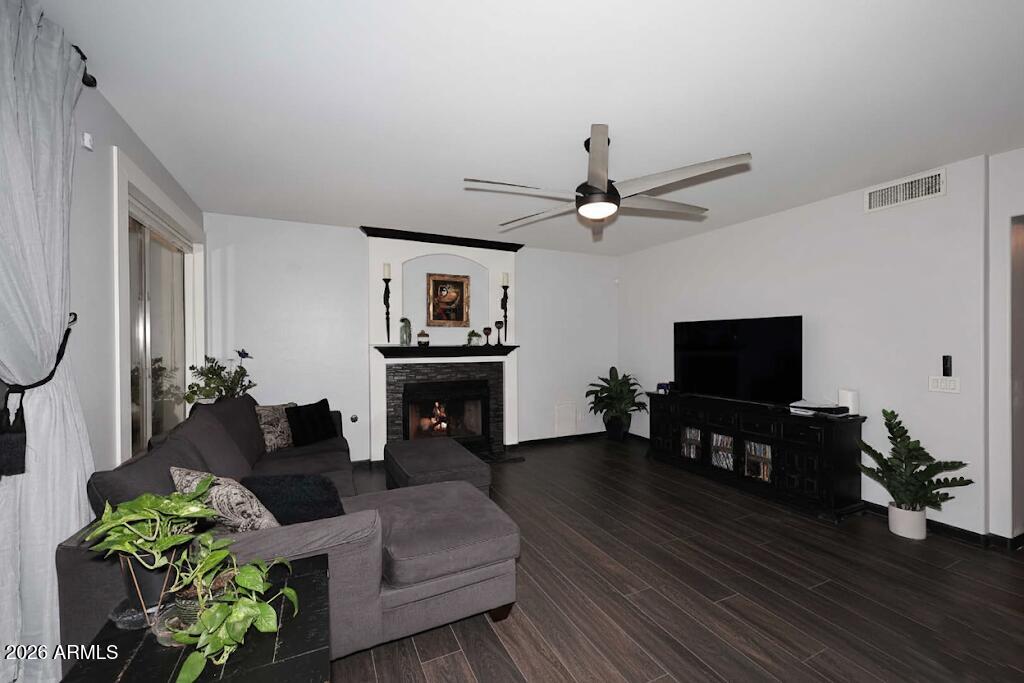 7272 West Crystal Road Glendale, AZ 85308 - Photo 11 of 52 a living room with furniture a flat screen tv and a fireplace