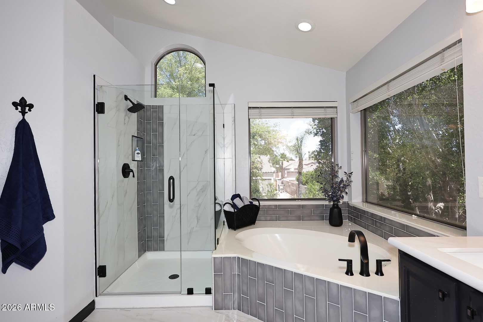 7272 West Crystal Road Glendale, AZ 85308 - Photo 23 of 52 a bathroom with a bathtub a sink a window and a shower