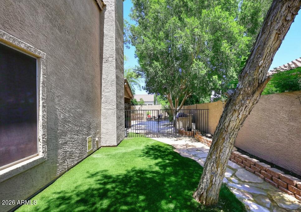7272 West Crystal Road Glendale, AZ 85308 - Photo 36 of 52 a view of a backyard with couches plants and large tree