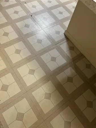 a dirty bathroom with white tiles