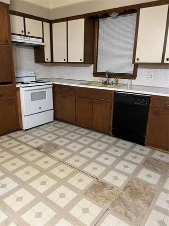a kitchen with a sink stove and cabinets
