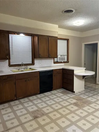 a kitchen with a sink stove and cabinets