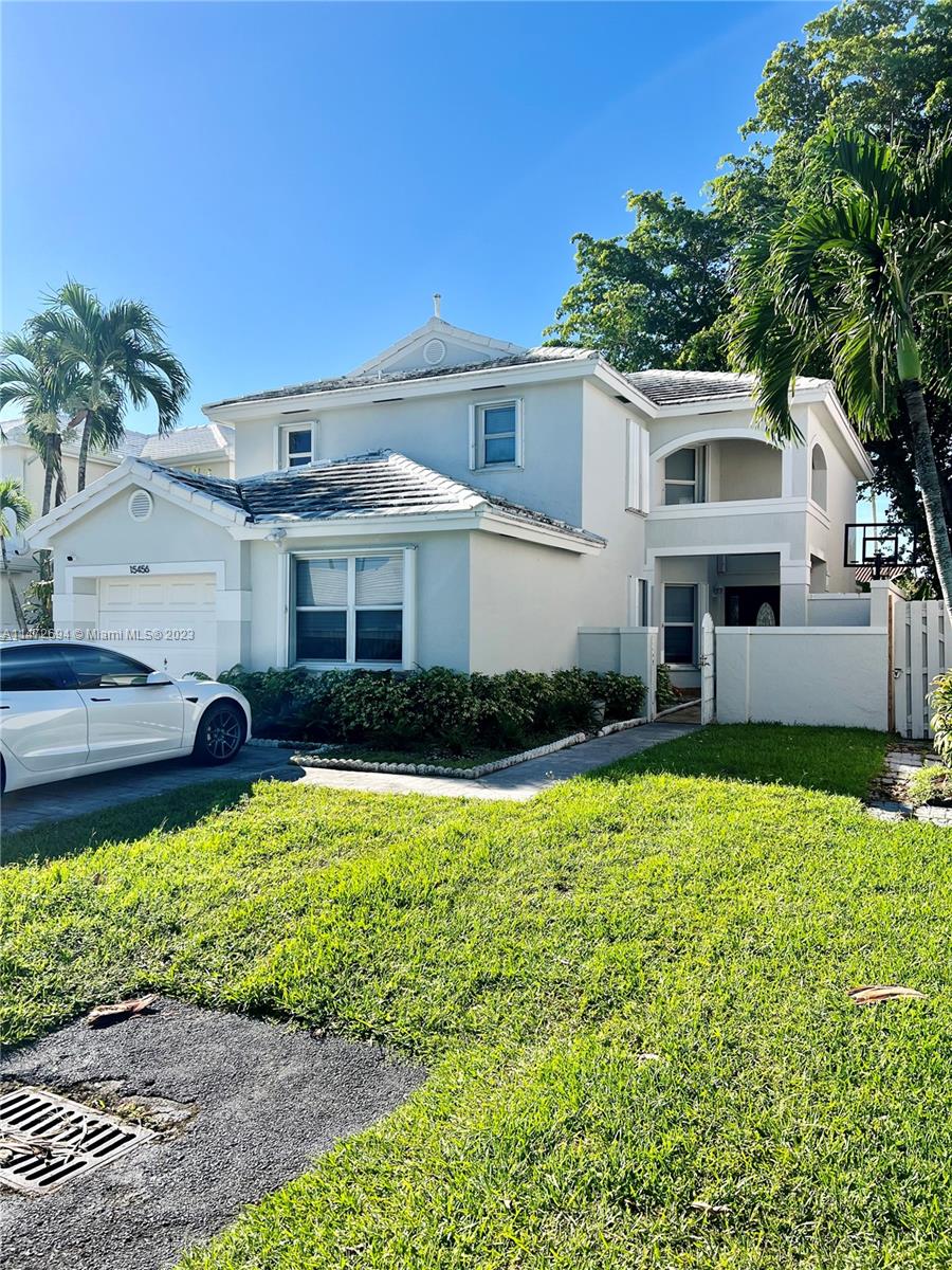 a front view of a house with a yard