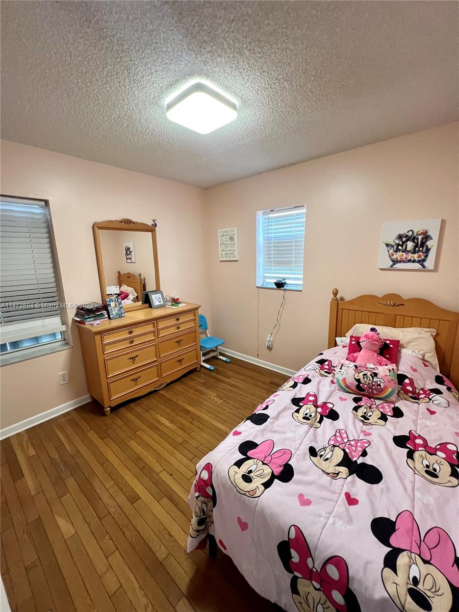 West End Miami, FL 33185 - Photo 18 of 30 a bedroom with two beds and a dresser