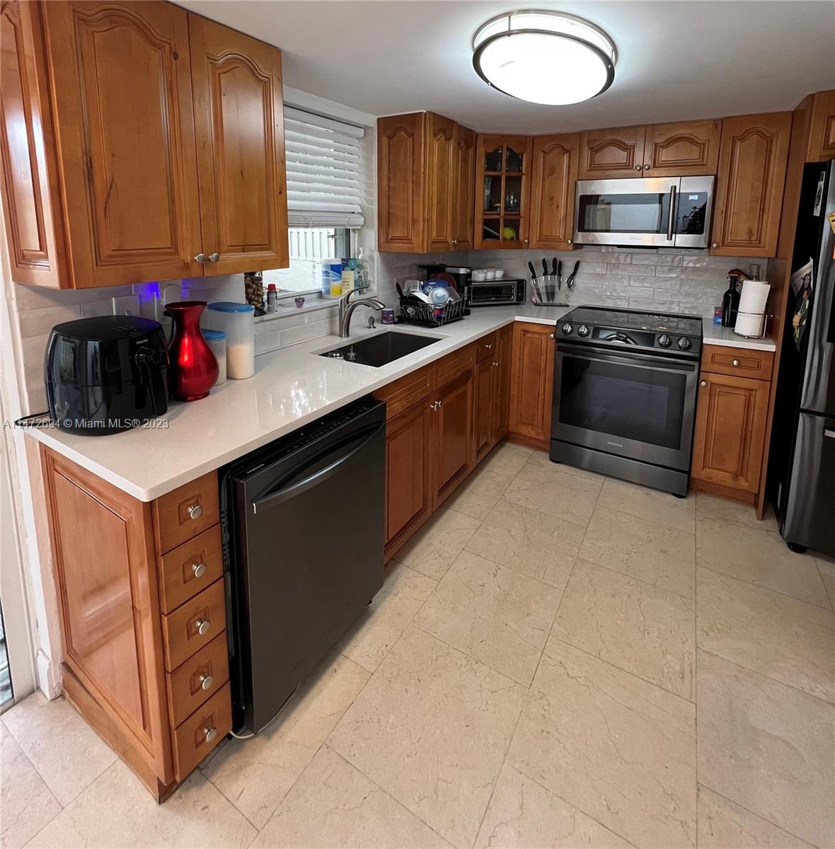 West End Miami, FL 33185 - Photo 22 of 30 a kitchen with a sink a stove and cabinets