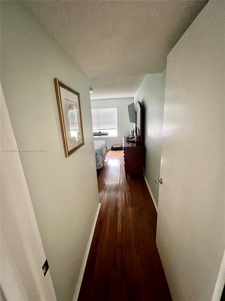West End Miami, FL 33185 - Photo 7 of 30 a view of a hallway with wooden floor and furniture