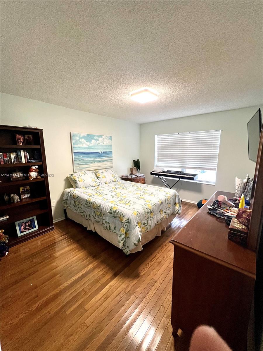 West End Miami, FL 33185 - Photo 8 of 30 a bedroom with a bed and wooden floor