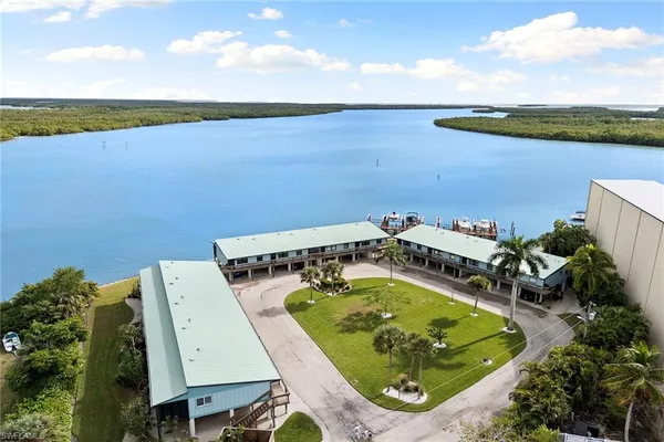 an aerial view of a house with a garden and lake view