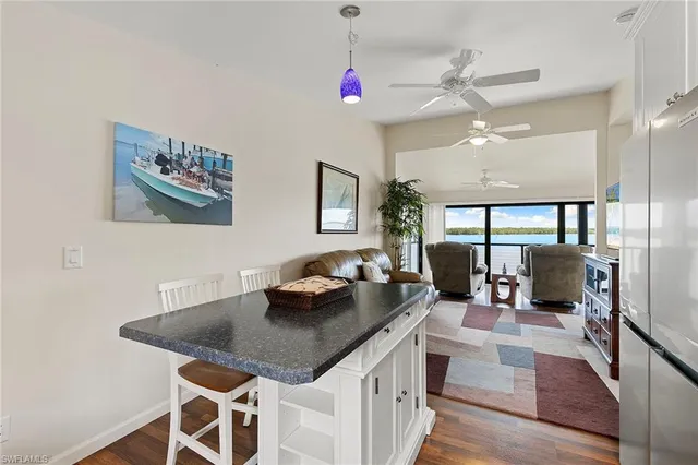 a view of a dining room with furniture a chandelier and wooden floor