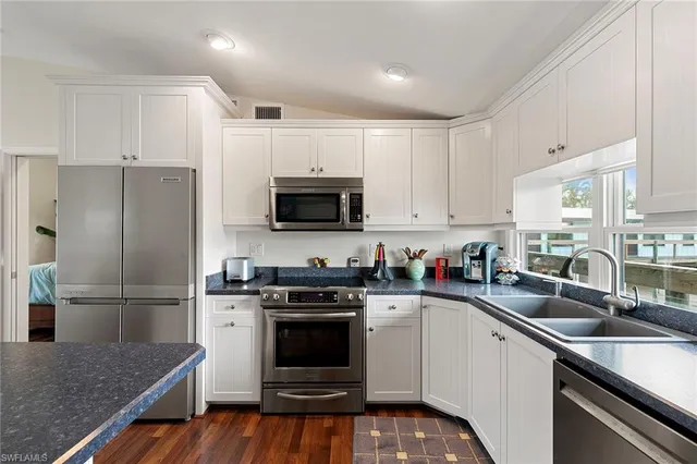 a kitchen with a sink stove and refrigerator