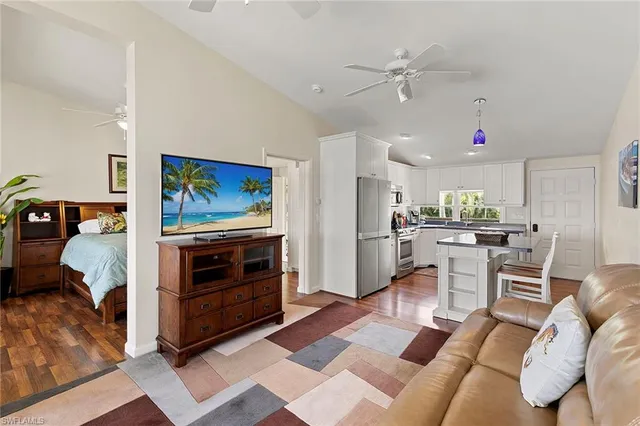 a living room with furniture and kitchen view