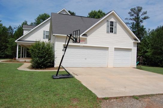 100 Lower Simmons Road Macon, GA 31220 - Photo 2 of 34 a small white house with a yard and a garden