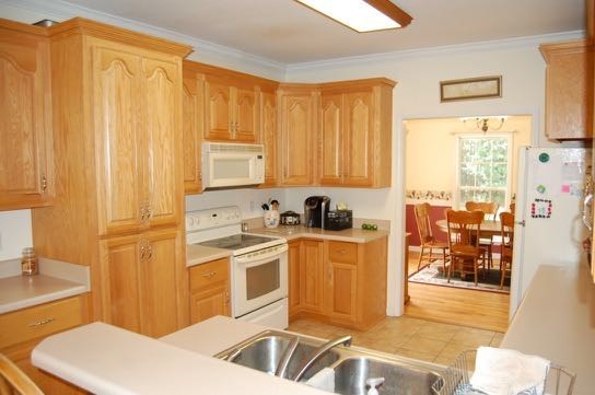 100 Lower Simmons Road Macon, GA 31220 - Photo 11 of 34 a kitchen with stainless steel appliances a white cabinets and a stove top oven