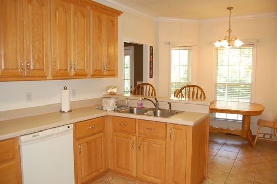 100 Lower Simmons Road Macon, GA 31220 - Photo 12 of 34 a kitchen with stainless steel appliances wooden cabinets a sink and a stove