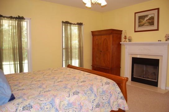 100 Lower Simmons Road Macon, GA 31220 - Photo 14 of 34 a bedroom with a bed and a fireplace