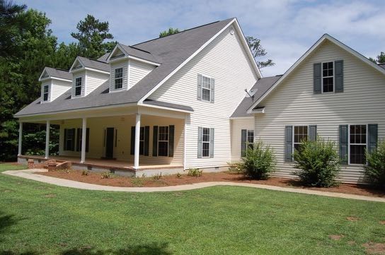 100 Lower Simmons Road Macon, GA 31220 - Photo 25 of 34 a front view of a house with plants and chairs