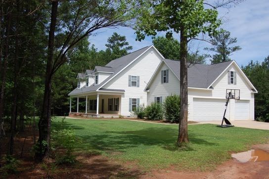 100 Lower Simmons Road Macon, GA 31220 - Photo 4 of 34 a front view of a house with a yard and trees