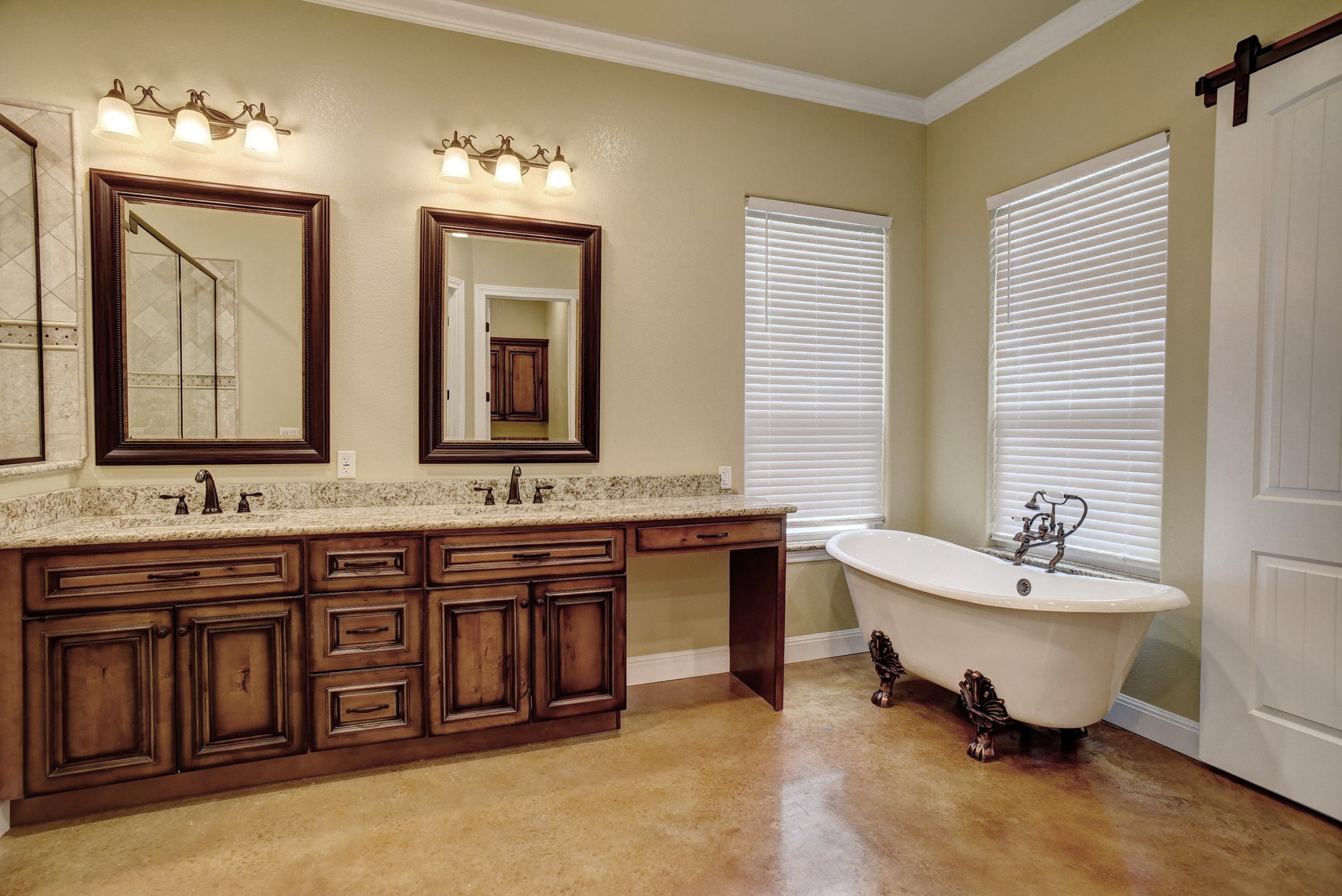 115 Pine Point Cove Elgin, TX 78621 - Photo 17 of 39 Dual vanities with granite counters and a charming clawfoot tub create a peaceful retreat.