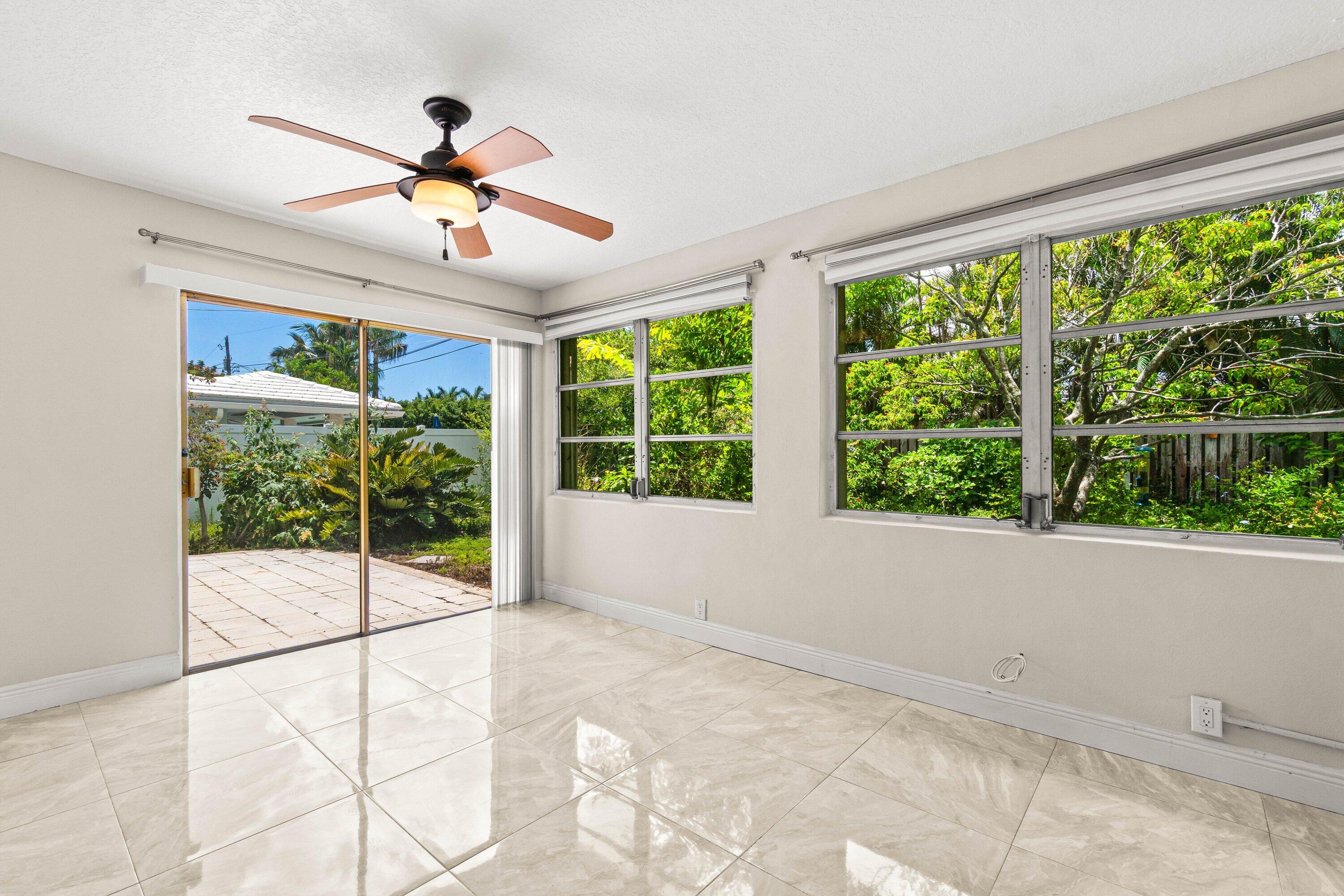 1290 Southwest 8th Street Boca Raton, FL 33486 - Photo 14 of 29 a view of a livingroom with a ceiling fan and window