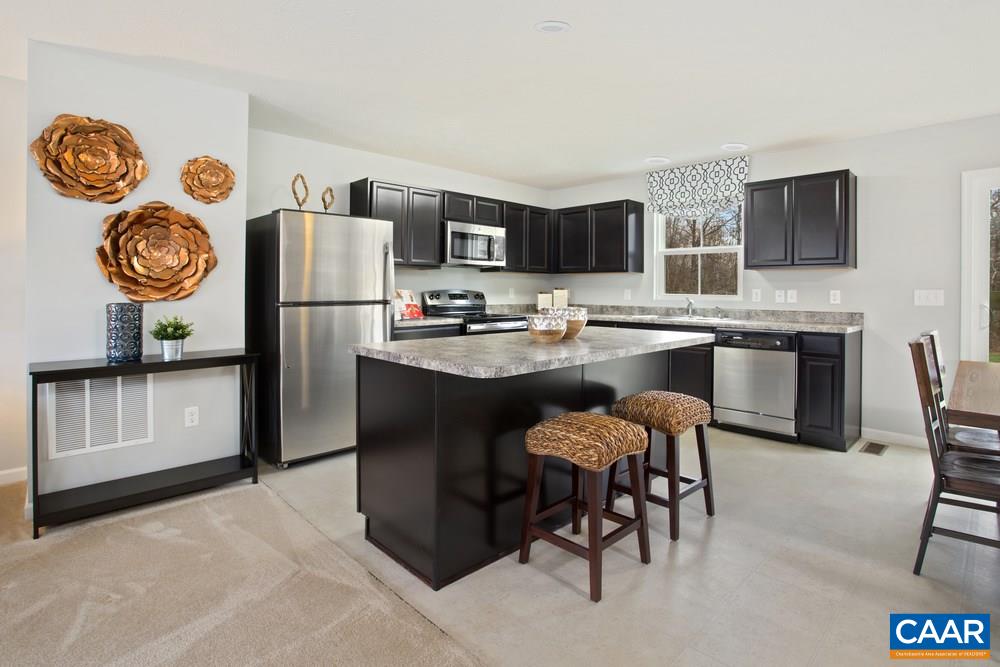 96 Oland Street Ruckersville, VA 22968 - Photo 2 of 18 a kitchen with stainless steel appliances granite countertop a refrigerator a stove a sink a dining table and chairs with wooden floor