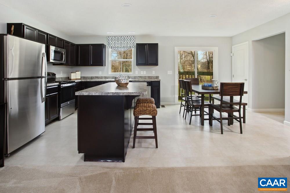 96 Oland Street Ruckersville, VA 22968 - Photo 3 of 18 a kitchen with stainless steel appliances granite countertop a refrigerator a stove a microwave a dining table and chairs
