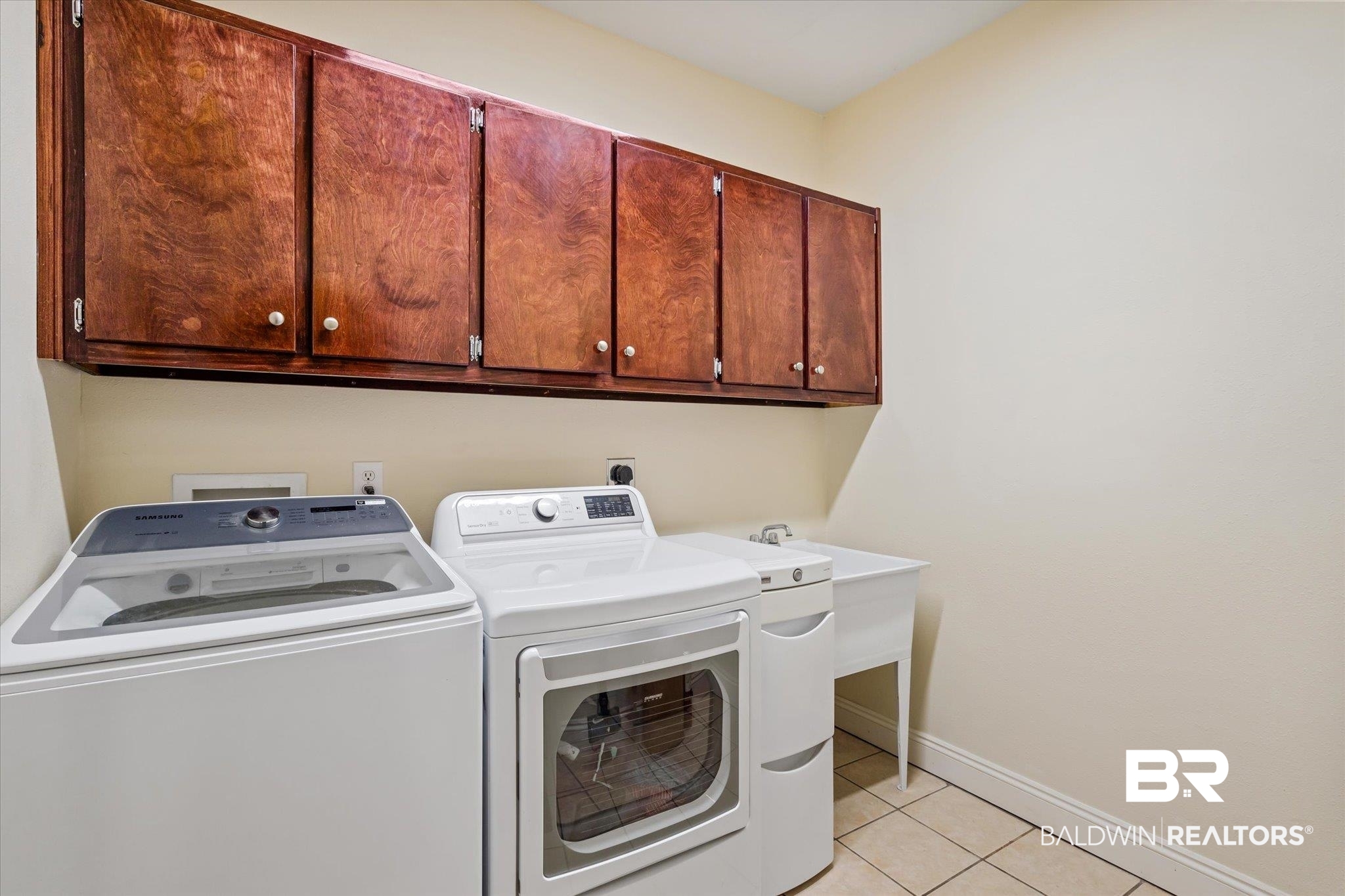 72 Limestone Drive Jackson, AL 36545 - Photo 17 of 38 Clothes washing area featuring cabinets, independent washer and dryer, and light tile patterned flooring