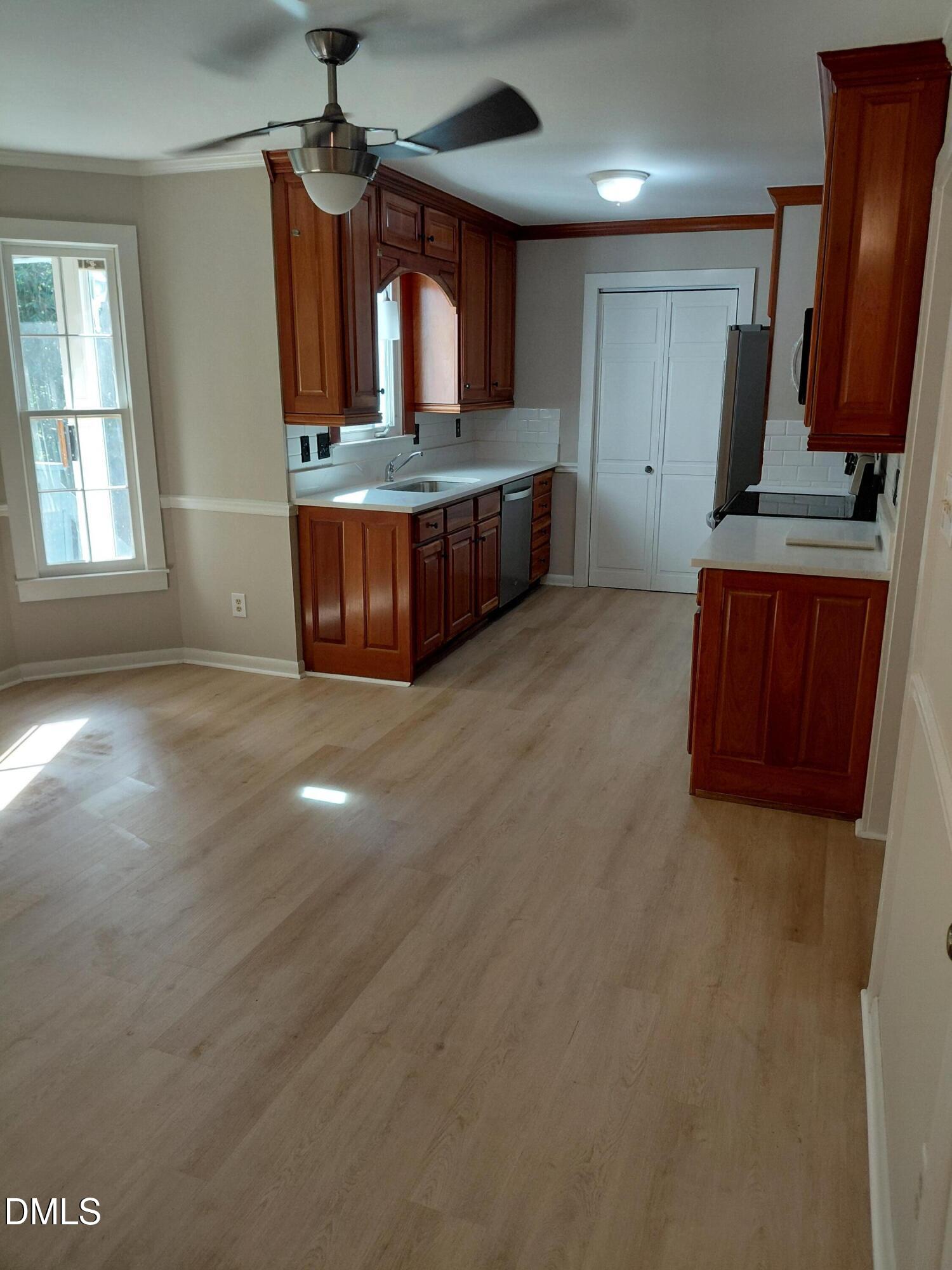 804 Olive Street Apex, NC 27502 - Photo 20 of 60 a kitchen with granite countertop a stove and a sink