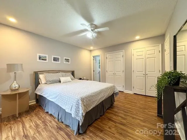 a spacious bedroom with a bed and a chandelier