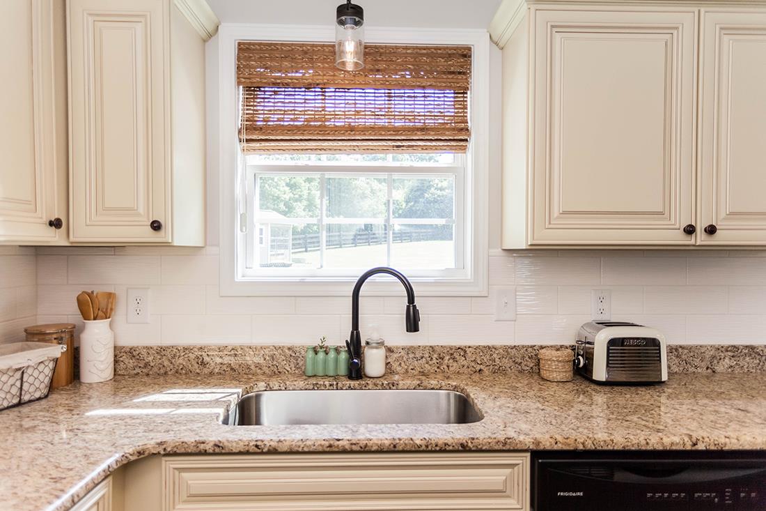4623 Washington Road Greenbrier, TN 37073 - Photo 8 of 23 a kitchen with granite countertop white cabinets and window