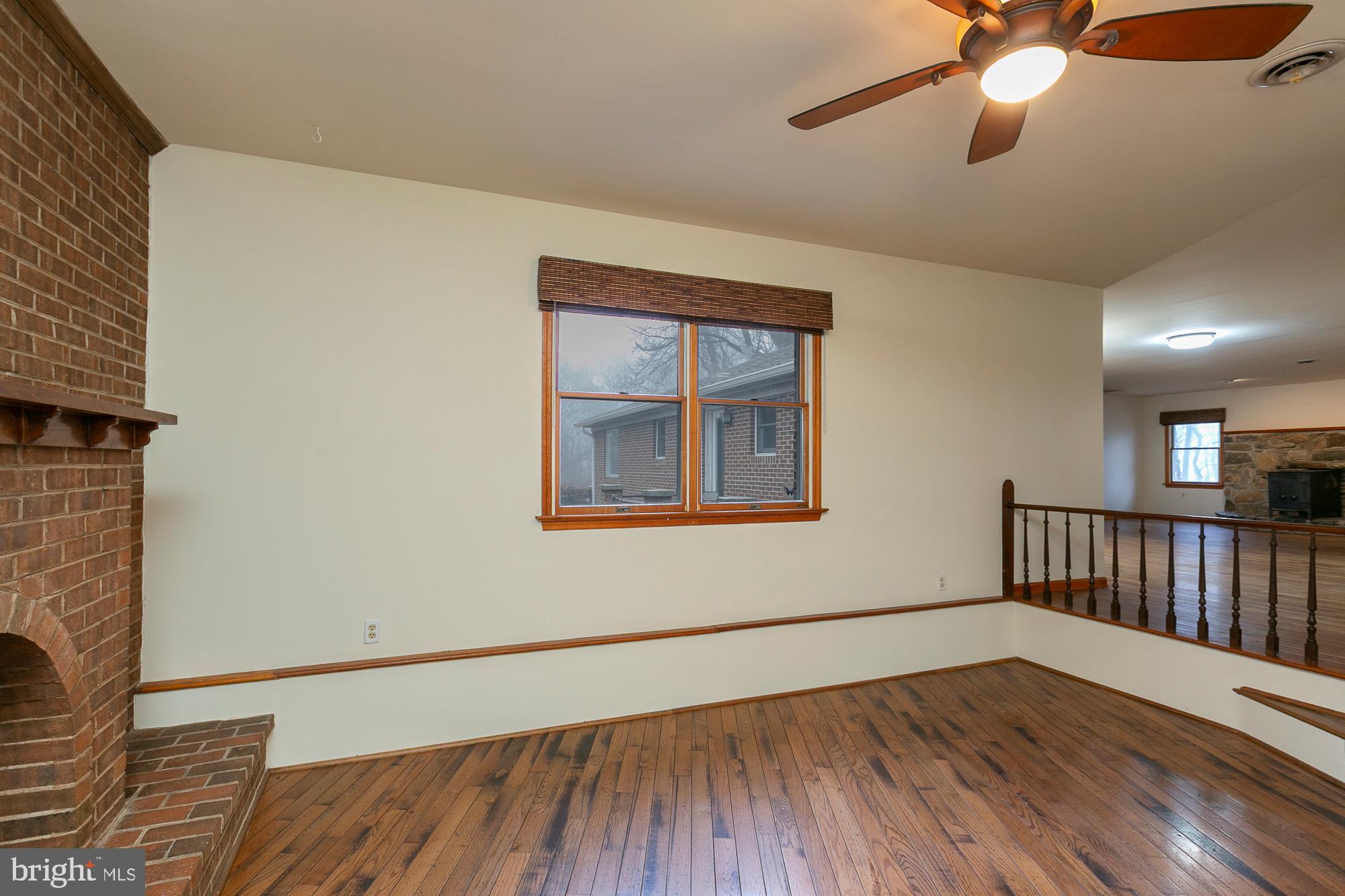 35 Grant Road Kearneysville, WV 25430 - Photo 17 of 122 a view of an empty room with window and wooden floor