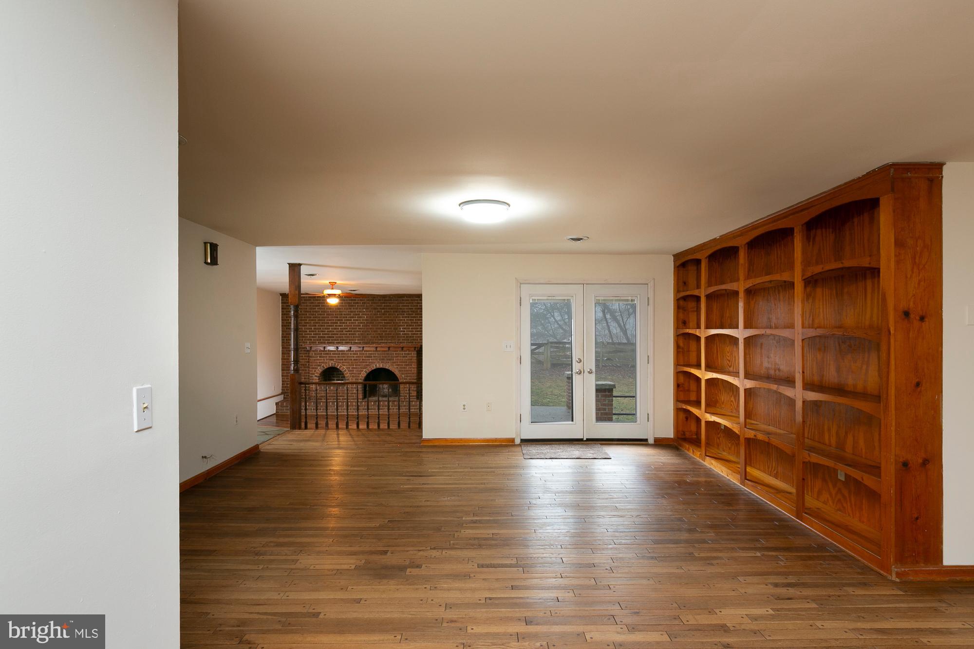 35 Grant Road Kearneysville, WV 25430 - Photo 26 of 122 a view of an empty room with wooden floor and a window