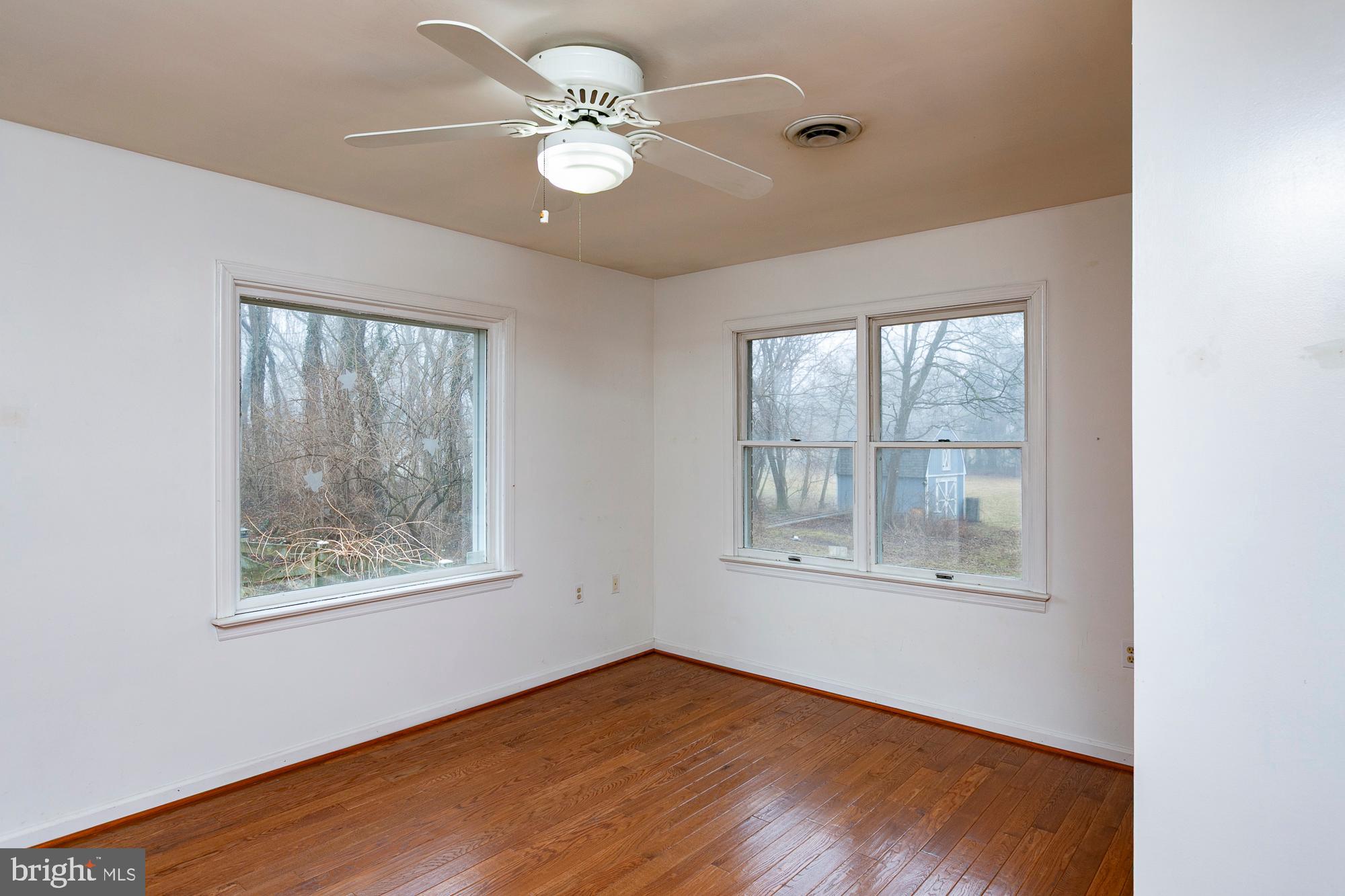 35 Grant Road Kearneysville, WV 25430 - Photo 57 of 122 a view of an empty room with a window and wooden floor