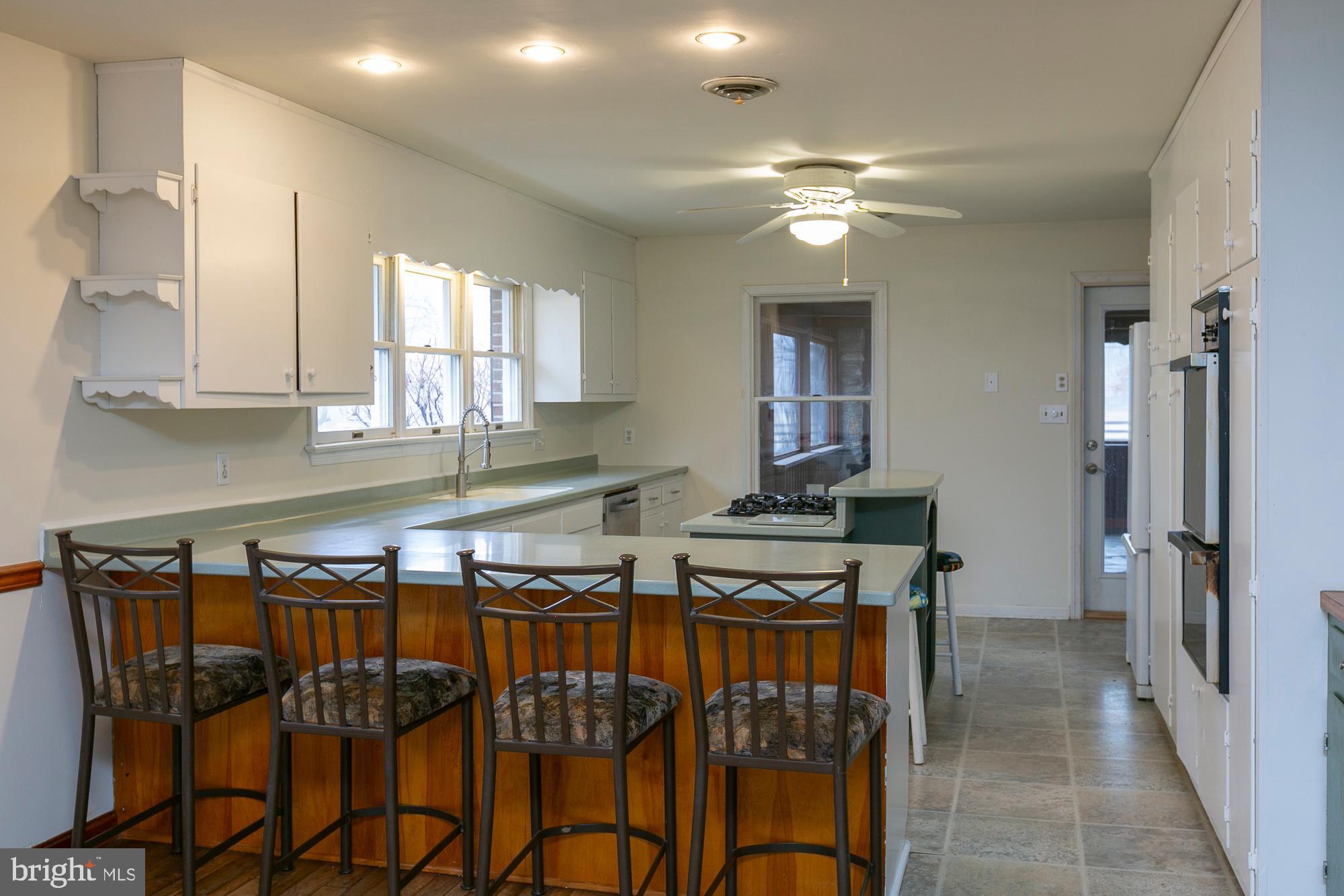 35 Grant Road Kearneysville, WV 25430 - Photo 77 of 122 a kitchen with stainless steel appliances granite countertop a stove top oven a refrigerator and cabinets