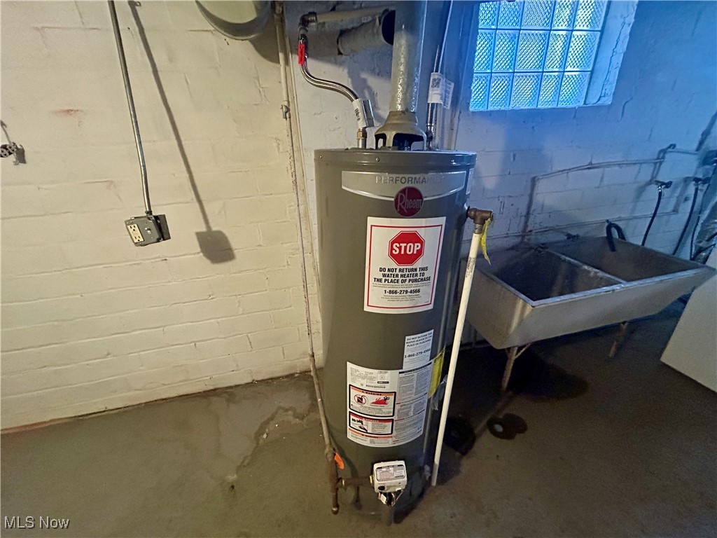 10202 Kinsman Road Cleveland, OH 44104 - Photo 14 of 15 Utilities featuring gas water heater and a sink