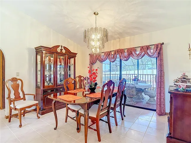 a living room with furniture a ceiling fan and a flat screen tv