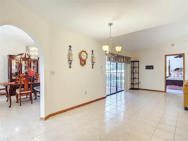 a living room with furniture a flat screen tv and a large window