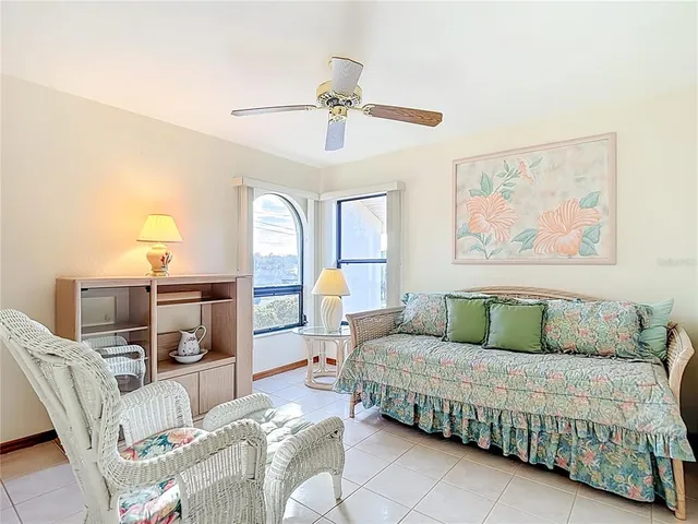 a bedroom with a bed a chandelier and a large mirror on the dresser