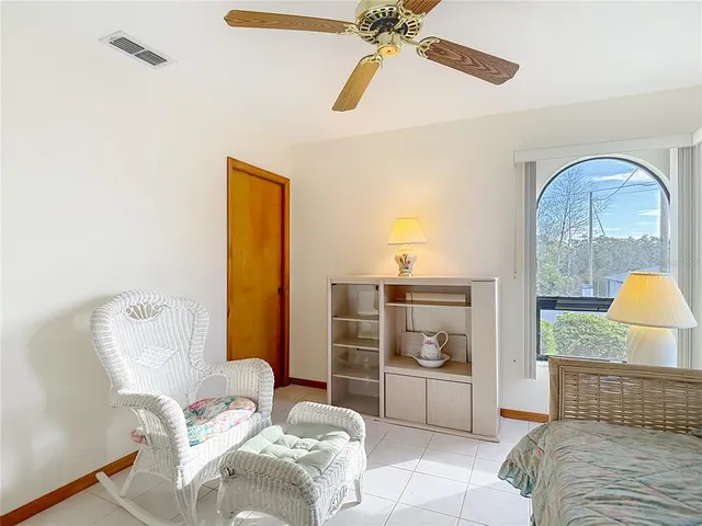 a spacious bathroom with a granite countertop sink a toilet and a mirror