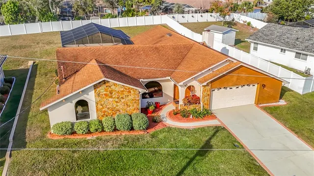 a backyard of a house with lots of green space and fountain