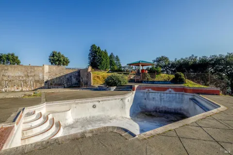 a swimming pool with outdoor seating and plants