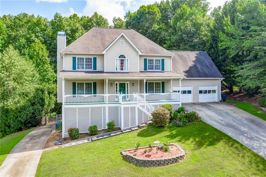 Harrison District with rocking chair front porch and dual driveways!