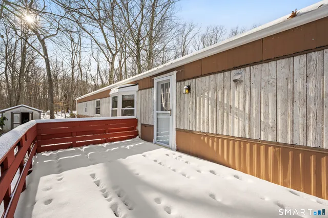 a view of a house with a wooden fence