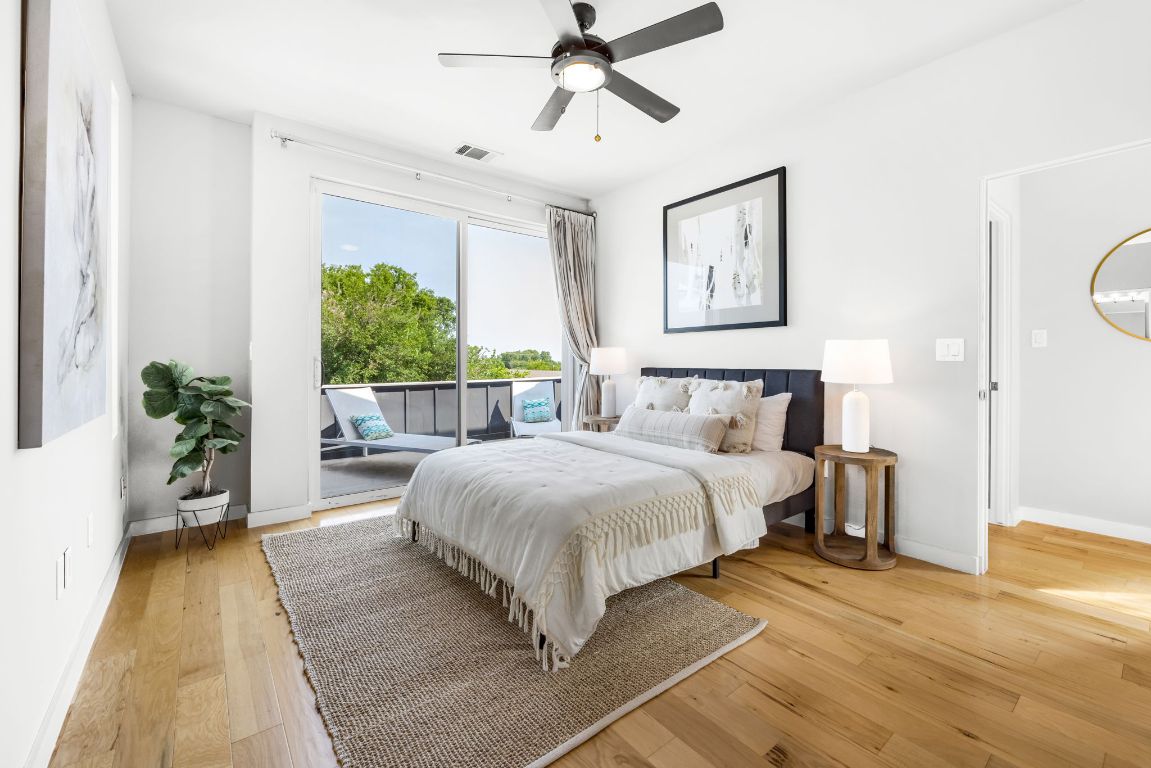 2203 East 51st Street, Unit A Austin, TX 78723 - Photo 14 of 25 a spacious bedroom with a bed and a potted plant