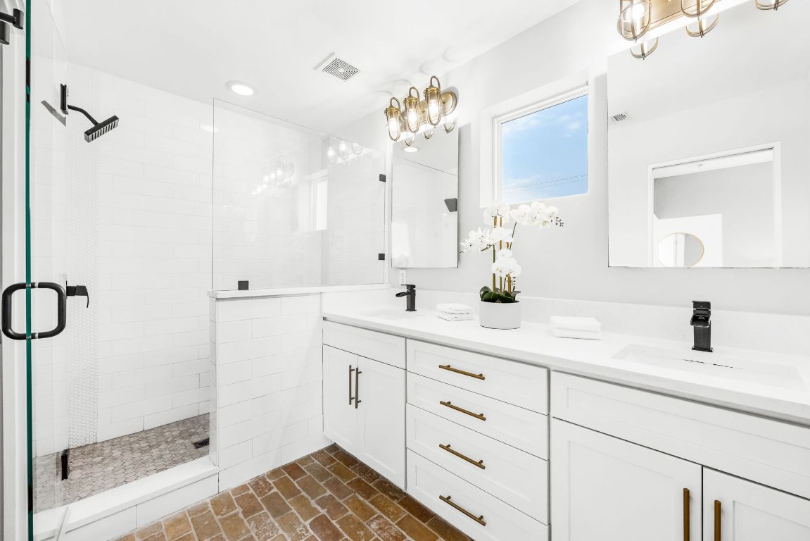 2203 East 51st Street, Unit A Austin, TX 78723 - Photo 18 of 25 a bathroom with a sink mirror and a shower