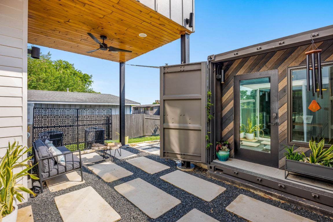 2203 East 51st Street, Unit A Austin, TX 78723 - Photo 4 of 25 a view of a patio with table and chairs under an umbrella