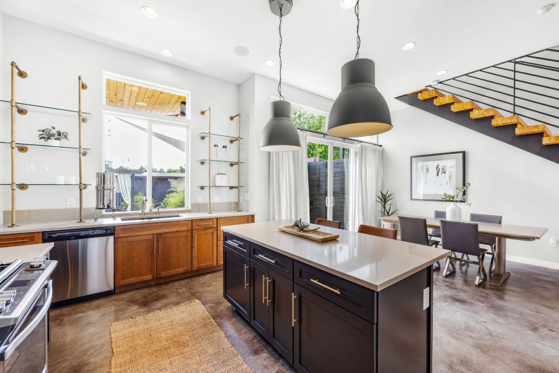2203 East 51st Street, Unit A Austin, TX 78723 - Photo 7 of 25 a kitchen with stainless steel appliances granite countertop a stove a sink and a refrigerator