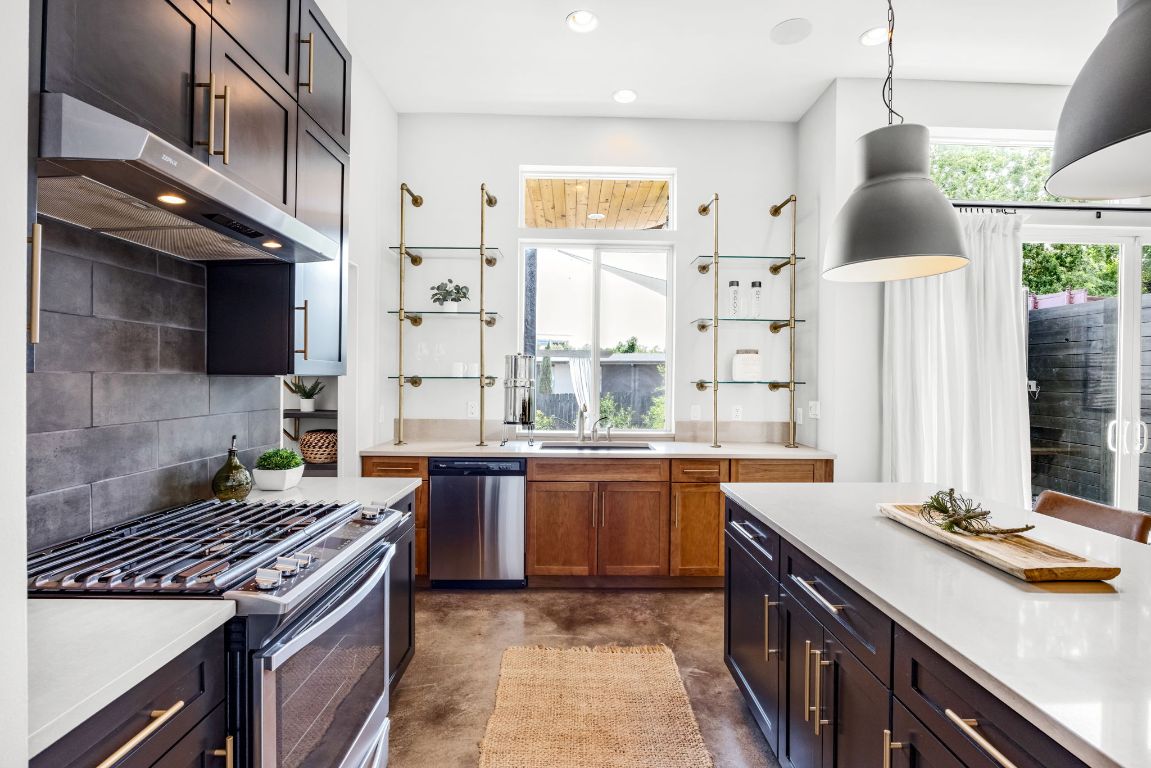 2203 East 51st Street, Unit A Austin, TX 78723 - Photo 9 of 25 a kitchen with stainless steel appliances granite countertop a sink stove and refrigerator