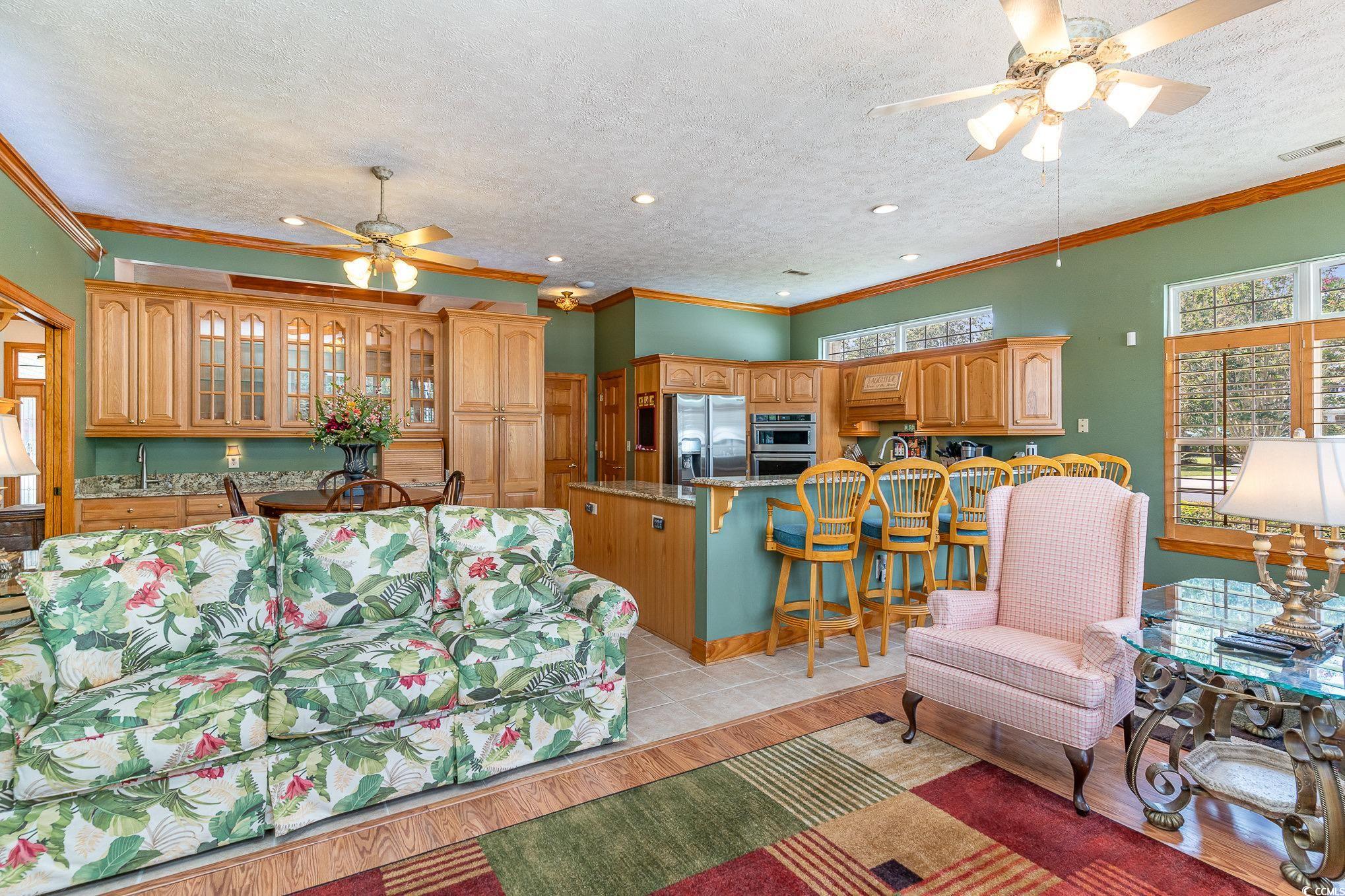 4003 Bayfield Loop Murrells Inlet, SC 29576 - Photo 34 of 40 Living room featuring a textured ceiling, crown mo