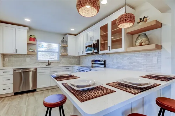 a kitchen with a stove a sink and a stove