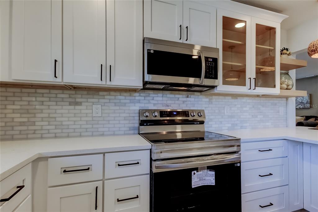 509 11th Street Northwest Largo, FL 33770 - Photo 14 of 36 a kitchen with appliances a sink and cabinets